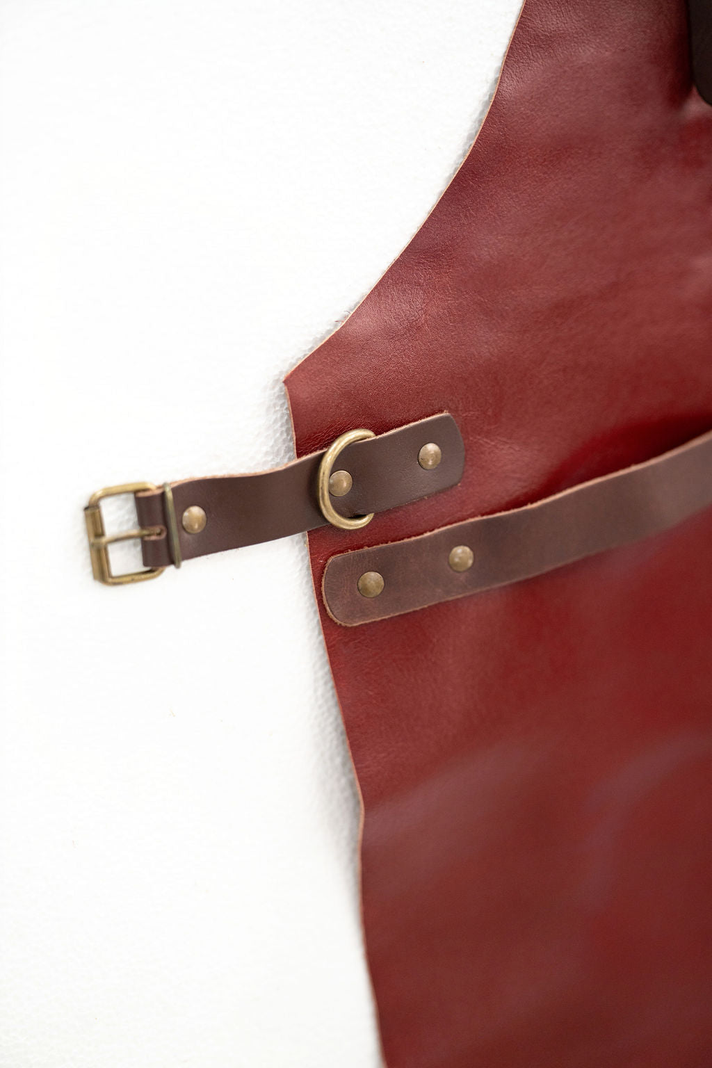 Elegant red leather apron minimal aesthetic for creative professionals