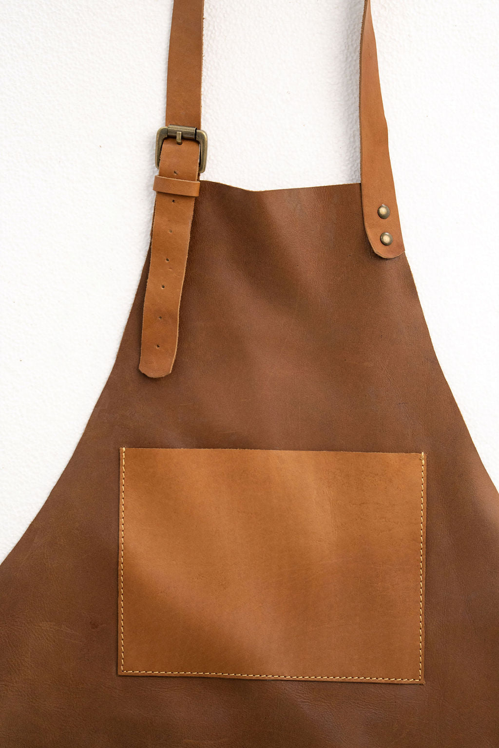 Lightweight tan leather apron with pockets for workshop and kitchen use