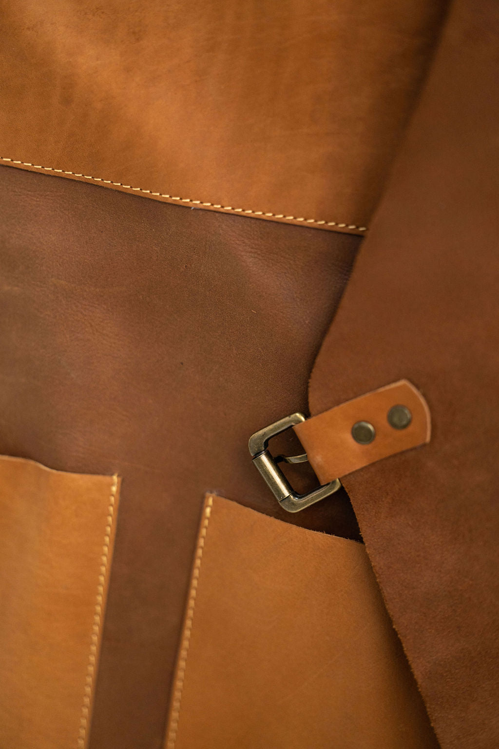 Minimal compact tan leather apron with pockets for barbers and makers