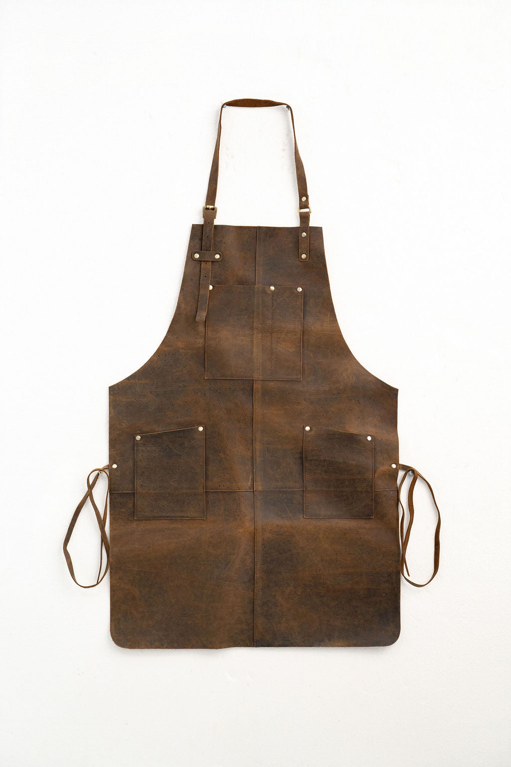 Full coverage brown leather apron with tool pockets for workshop use