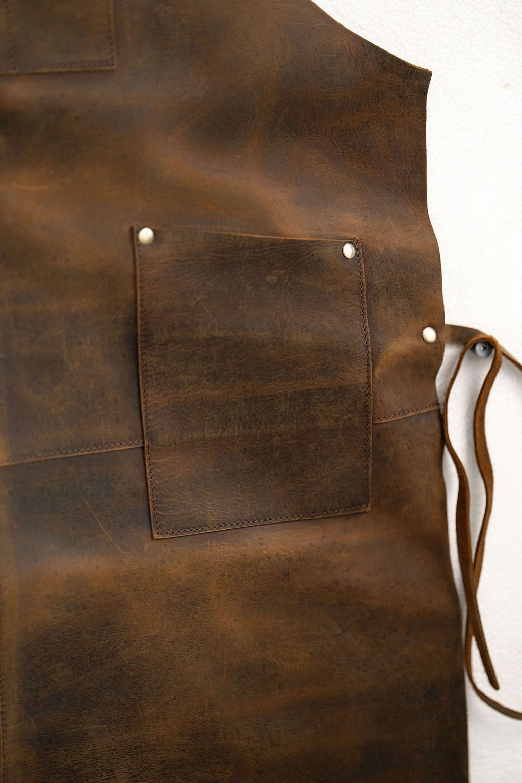 Rugged heavy duty brown leather apron with functional front pockets