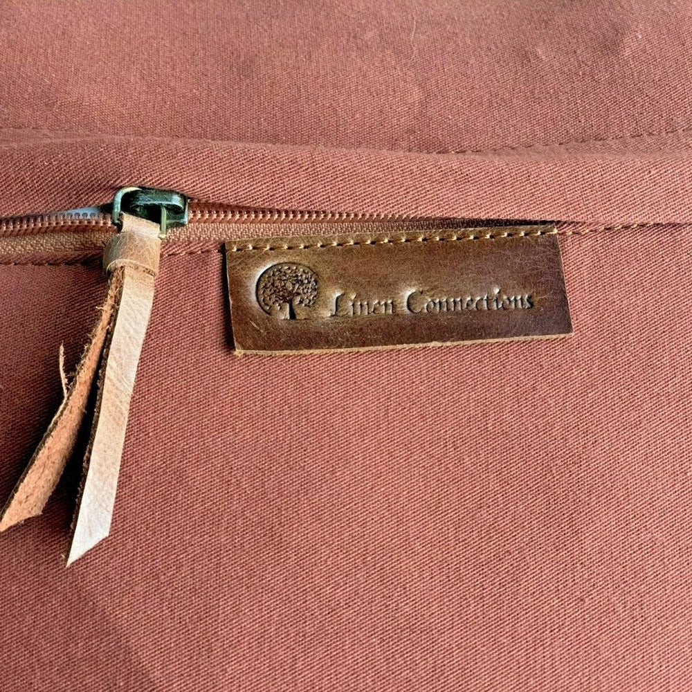 Flat lay of 100% genuine leather cushion cover – Glam Thread handmade rustic tan pillow.