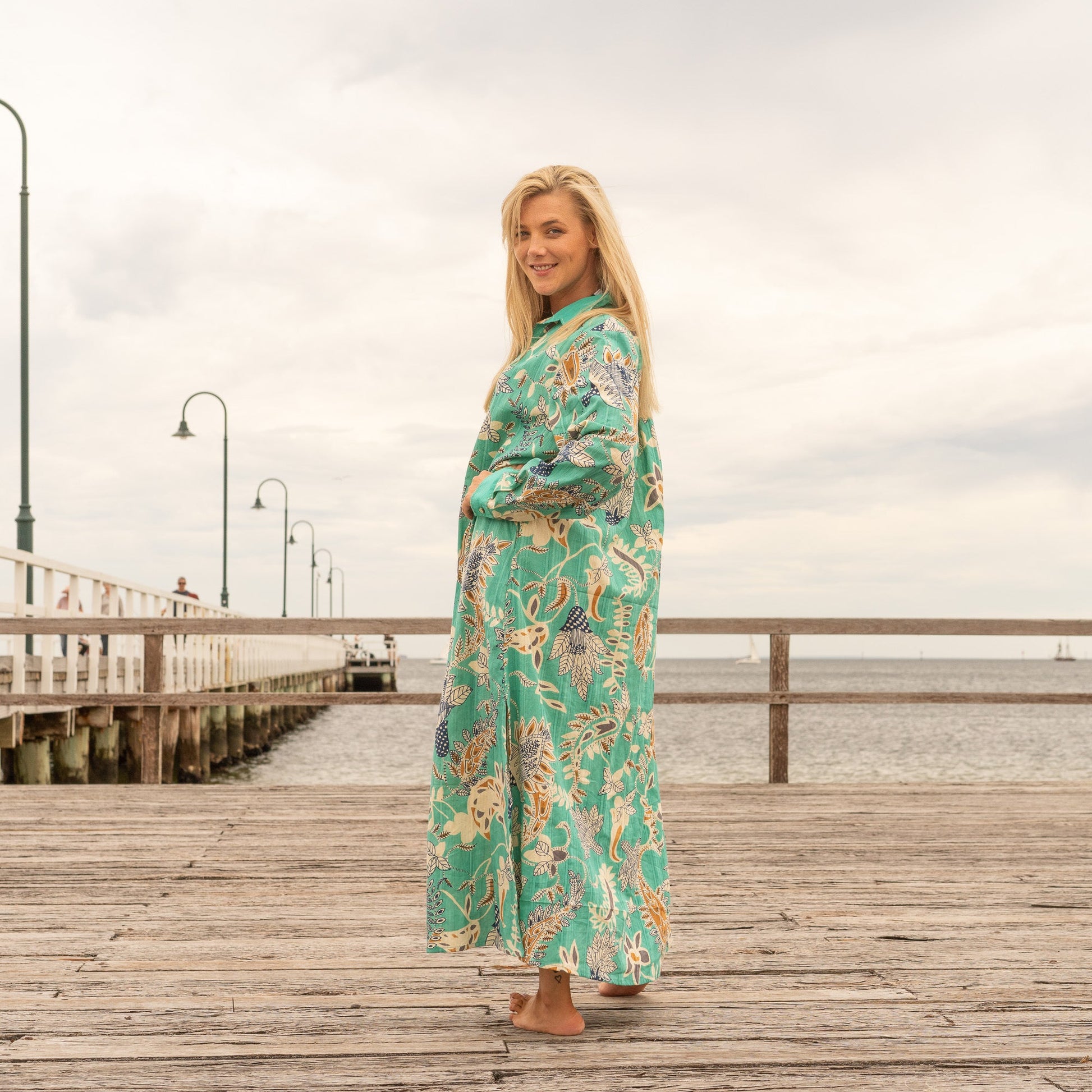 Women wearing emerald green botanical cotton maxi dress for summer vacation