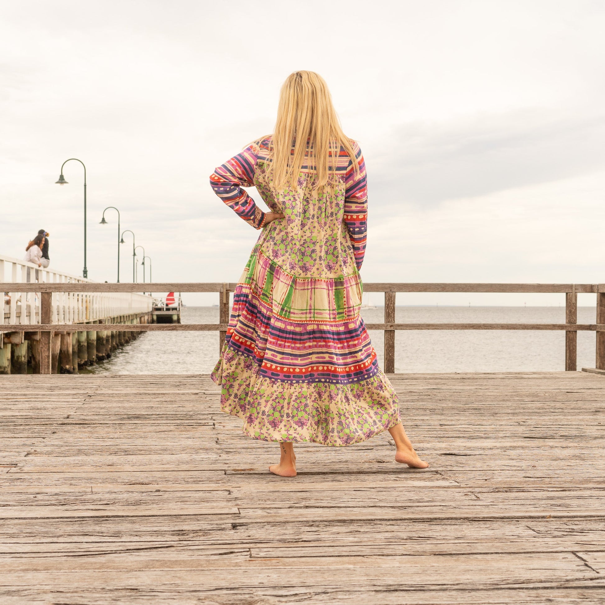 Close-up detail of floral patchwork fabric on boho luxe maxi dress
