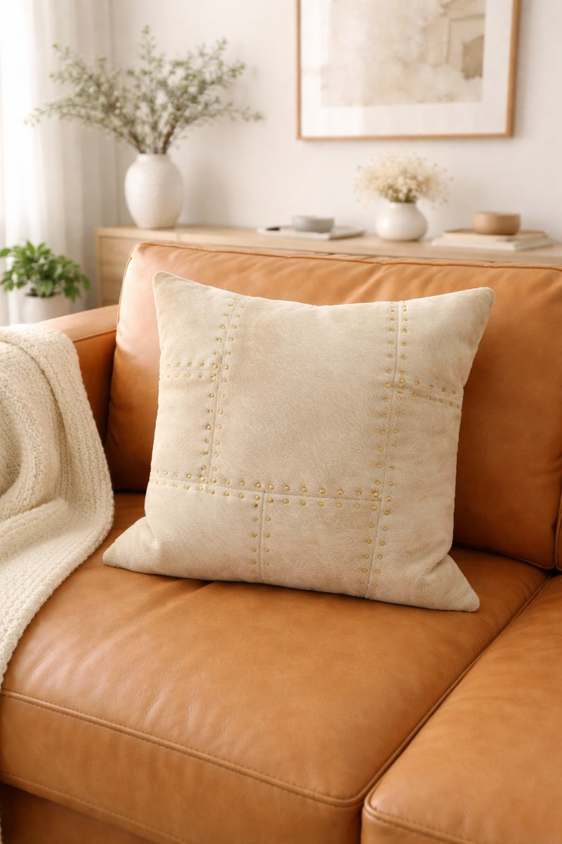 Elegant ivory cowhide leather cushion cover with decorative brass studs for glam decor