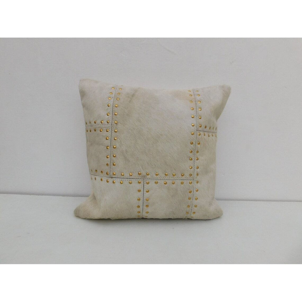 Premium ivory cowhide leather cushion cover with brass stud embellishment for luxury interiors
