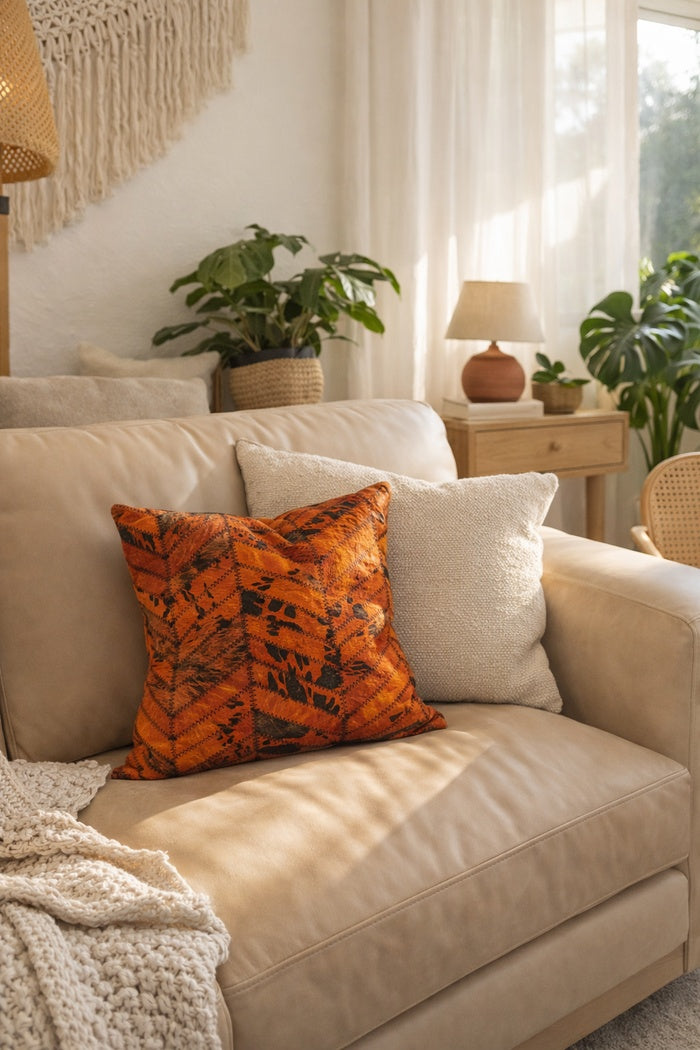 Modern glam orange & black cowhide leather cushion cover for stylish living spaces