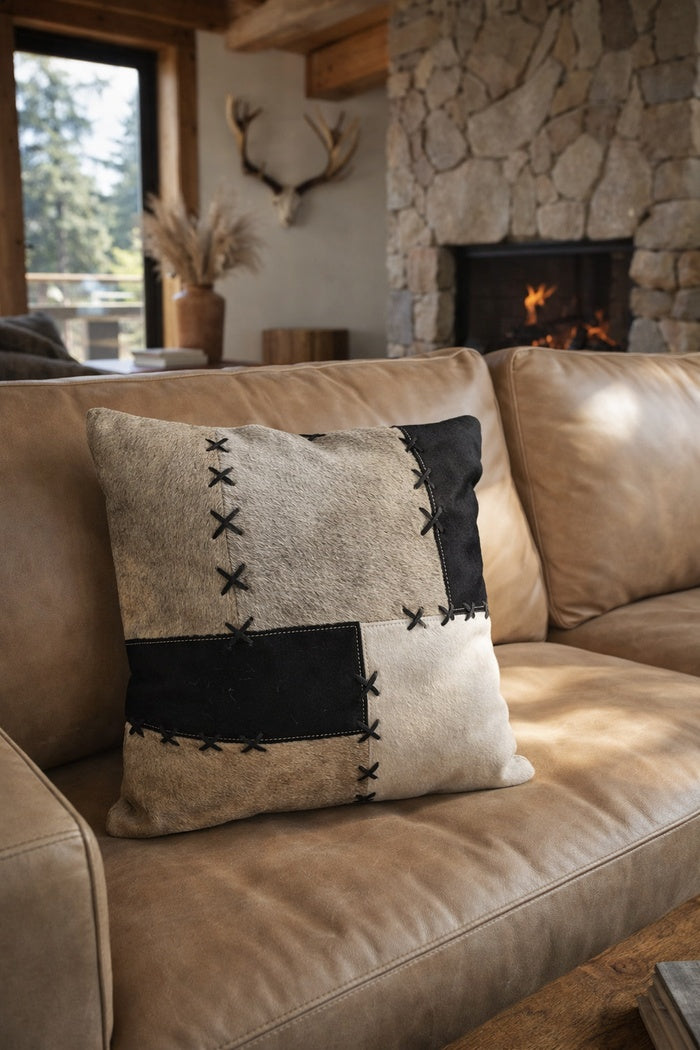 Close up of premium cowhide patchwork cushion showing hair-on-hide texture and stitching